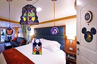 A stateroom decorated with various Disney themed Halloween ornaments and magnets