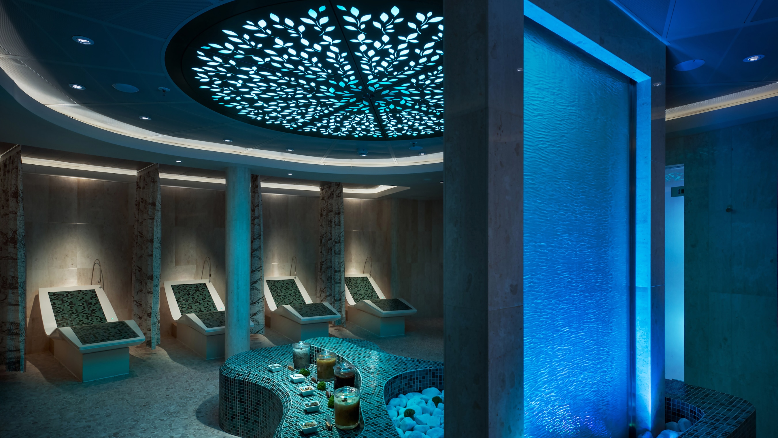 Unwind and let the tension melt away at The Rainforest at Senses Spa. A spa with a fountain, seats and candles