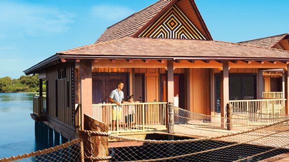 List Of Destinations Disney Vacation Club A Father And Son Wearing Mickey Ears On The Porch Of Polynesian Themed
