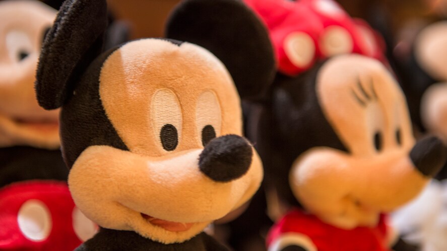 A plush Mickey Mouse next to a plush Minnie Mouse