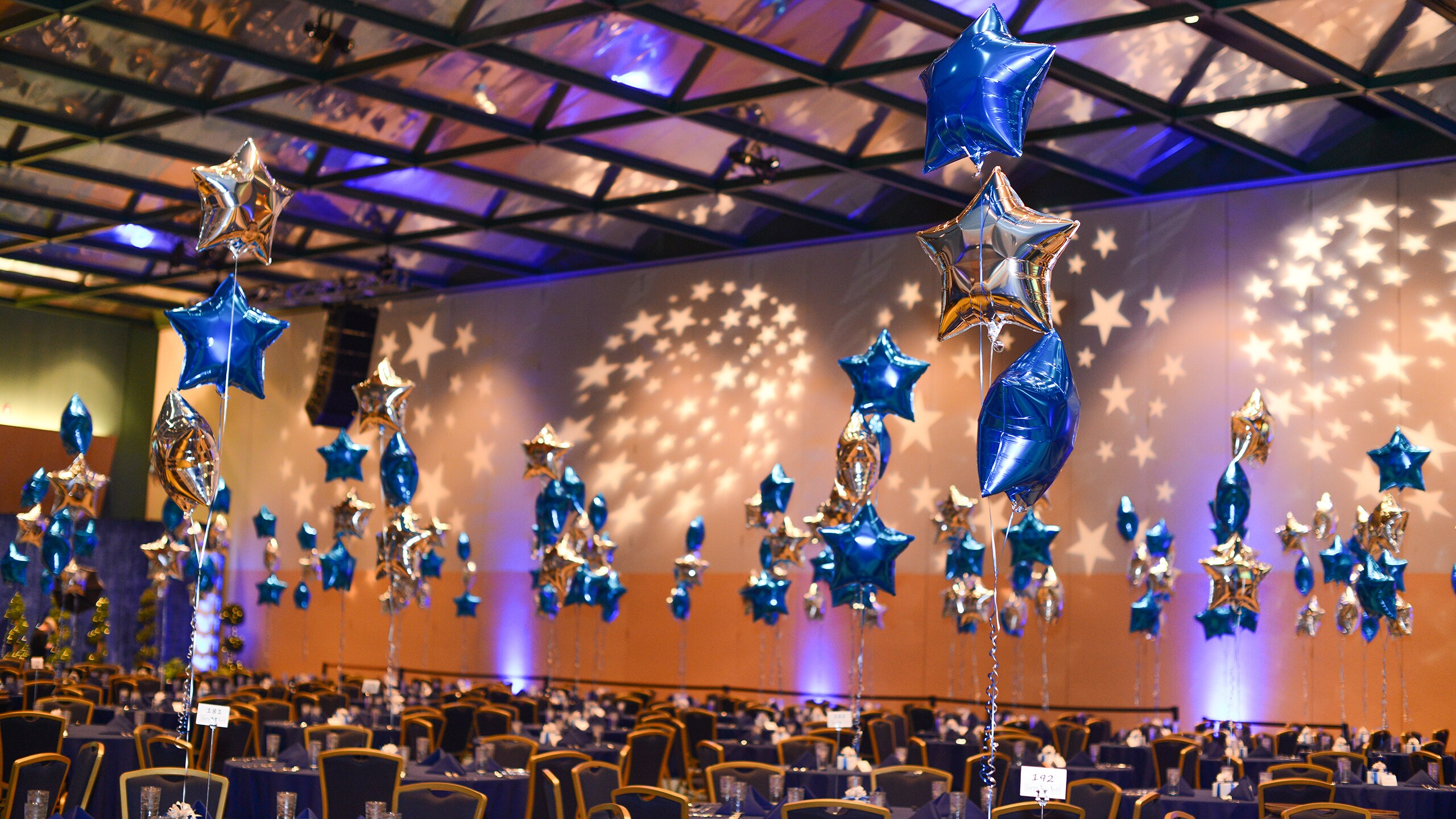 A large room decorated with balloons and projections